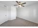 Neutral bedroom with light carpet, a ceiling fan, and a closet, offering a serene living space at 1062 Rockhurst Dr # 302, Highlands Ranch, CO 80129