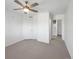 Cozy bedroom features light carpet, a ceiling fan, closet and ensuite bathroom access at 1062 Rockhurst Dr # 302, Highlands Ranch, CO 80129