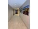 Apartment hallway featuring neutral colored walls and flooring with mountain artwork at 1062 Rockhurst Dr # 302, Highlands Ranch, CO 80129
