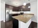 Contemporary kitchen boasts granite counters, stainless appliances, and dark wood cabinets at 1062 Rockhurst Dr # 302, Highlands Ranch, CO 80129