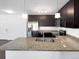 A modern kitchen features granite countertops, stainless steel appliances, and wood cabinets at 1062 Rockhurst Dr # 302, Highlands Ranch, CO 80129