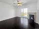 Bright living room featuring dark floors, a cozy fireplace, and sliding doors to a balcony at 1062 Rockhurst Dr # 302, Highlands Ranch, CO 80129