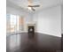 Bright living room featuring fireplace and slider to private balcony with views at 1062 Rockhurst Dr # 302, Highlands Ranch, CO 80129