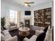Staged living room featuring a fireplace, built-in shelving, and sliding glass doors at 1062 Rockhurst Dr # 302, Highlands Ranch, CO 80129