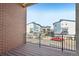 The private balcony provides a view of the well-maintained street and other architectural styled homes at 7812 W 43Rd Pl, Wheat Ridge, CO 80033