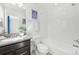 Stylish bathroom with vanity, framed mirror, shower over tub, and modern fixtures at 7812 W 43Rd Pl, Wheat Ridge, CO 80033