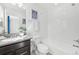 Well-lit bathroom with a single sink vanity, framed mirror and shower-tub combo at 7812 W 43Rd Pl, Wheat Ridge, CO 80033