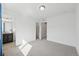 Bright bedroom featuring neutral carpet, walk-in closet, and an ensuite bathroom at 7812 W 43Rd Pl, Wheat Ridge, CO 80033