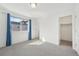 Bedroom with neutral carpet, and closet, and a large window with blue curtains at 7812 W 43Rd Pl, Wheat Ridge, CO 80033