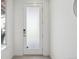 Bright foyer featuring tile flooring and a frosted glass front door at 7812 W 43Rd Pl, Wheat Ridge, CO 80033