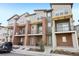 Modern townhomes with brick and gray siding, balconies, and well-kept landscaping at 7812 W 43Rd Pl, Wheat Ridge, CO 80033