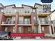 Modern townhome with brick accents, balconies, and contemporary design elements at 7812 W 43Rd Pl, Wheat Ridge, CO 80033