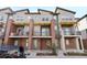 Townhome exterior with brick accents, balconies, and a gray painted exterior at 7812 W 43Rd Pl, Wheat Ridge, CO 80033