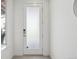 Bright foyer with a frosted glass front door and light tile flooring at 7812 W 43Rd Pl, Wheat Ridge, CO 80033