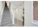 Modern hallway with stairs, neutral-toned tile flooring, and a plant at 7812 W 43Rd Pl, Wheat Ridge, CO 80033