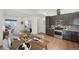 This open concept floor plan features the kitchen with seating flowing into the dining and living spaces at 7812 W 43Rd Pl, Wheat Ridge, CO 80033