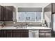 Close up of modern kitchen featuring stainless steel appliances and dark cabinets at 7812 W 43Rd Pl, Wheat Ridge, CO 80033