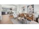 Open-concept living area with hardwood floors, stylish furniture, and a view into the kitchen at 7812 W 43Rd Pl, Wheat Ridge, CO 80033