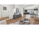 Well lit living room shows the nearby kitchen, modern decor and hardwood floors at 7812 W 43Rd Pl, Wheat Ridge, CO 80033
