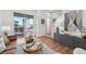 This living room boasts neutral paint, wood floors, a sliding glass door to a balcony, and modern decor at 7812 W 43Rd Pl, Wheat Ridge, CO 80033