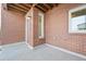 A cozy red brick patio that features a concrete floor and an overhead wood ceiling at 7812 W 43Rd Pl, Wheat Ridge, CO 80033