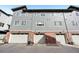 The rear exterior of the property featuring a row of garages and a modern architectural design at 7812 W 43Rd Pl, Wheat Ridge, CO 80033