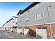 The back of the townhome boasts a modern design, with garages and durable siding material at 7812 W 43Rd Pl, Wheat Ridge, CO 80033