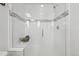 Modern glass walk-in shower with white tile and a built in bench at 7812 W 43Rd Pl, Wheat Ridge, CO 80033