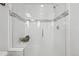 Modern bathroom shower showcasing white tile, glass enclosure, and sleek design, offering a spa-like experience at 7812 W 43Rd Pl, Wheat Ridge, CO 80033