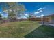 Backyard features a lush lawn, home exterior, privacy fence, and space for activities at 3940 S Hazel Ct, Englewood, CO 80110