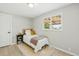 Bright bedroom with natural light, neutral walls, wood-look floors, and door access at 3940 S Hazel Ct, Englewood, CO 80110