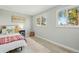 Bright bedroom with two large windows and neutral decor at 3940 S Hazel Ct, Englewood, CO 80110