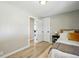 Bedroom with natural light highlighting an open door, with wood-look floors at 3940 S Hazel Ct, Englewood, CO 80110