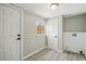 Hallway boasts wood-look floors, multiple doors, natural light, and fresh neutral paint at 3940 S Hazel Ct, Englewood, CO 80110