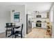 Open kitchen with stainless steel appliances and adjacent dining area at 3940 S Hazel Ct, Englewood, CO 80110
