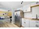 Modern kitchen with stainless steel refrigerator and stylish adjacent living area at 3940 S Hazel Ct, Englewood, CO 80110