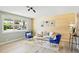 Bright living room with large windows and comfortable seating arrangement at 3940 S Hazel Ct, Englewood, CO 80110