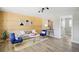 Cozy living room featuring a stylish wood accent wall and modern decor at 3940 S Hazel Ct, Englewood, CO 80110