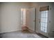 Bedroom with carpet, door to the hallway and door to the outside patio at 2980 W Centennial Dr # L, Littleton, CO 80123