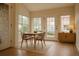 Bright dining area with large windows, hardwood floors, and modern furnishings creating an inviting space at 2980 W Centennial Dr # L, Littleton, CO 80123