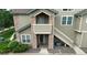 Attractive exterior with stone accents, second story balcony, and ample parking at 2980 W Centennial Dr # L, Littleton, CO 80123