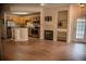Open-concept living room with fireplace, built-in shelves, and hardwood floors at 2980 W Centennial Dr # L, Littleton, CO 80123
