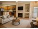 Cozy living room with fireplace, built-in shelving, and wood flooring provides a comfortable retreat at 2980 W Centennial Dr # L, Littleton, CO 80123