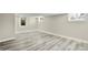 Finished basement with updated flooring, fresh paint, and natural light from above-ground windows at 3636 Ames St, Wheat Ridge, CO 80212