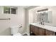 Bathroom featuring a dark vanity with white countertop and modern fixtures at 3636 Ames St, Wheat Ridge, CO 80212