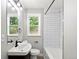 Updated bathroom with subway tile surround, vanity, and modern fixtures at 3636 Ames St, Wheat Ridge, CO 80212