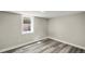 Cozy bedroom features gray wood floors and bright white trim at 3636 Ames St, Wheat Ridge, CO 80212