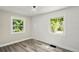 Bedroom featuring two windows with a shiplap accent wall, recessed lighting, and fresh paint at 3636 Ames St, Wheat Ridge, CO 80212