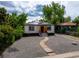 Charming home featuring solar panels, gravel landscaping, and a welcoming front entrance at 3636 Ames St, Wheat Ridge, CO 80212