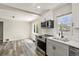 Bright kitchen featuring stainless appliances, grey cabinetry, and modern fixtures at 3636 Ames St, Wheat Ridge, CO 80212